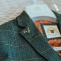 stag lapel pin on tweed suit