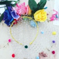 multi coloured pom pom headdress