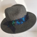 charcoal trilby with blue peacock feather trim