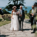 An ecstatic bride being led up the isle