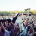 crowd surfing bride and groom