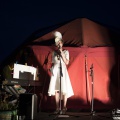 bride on stage still wearing her hat