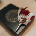 deep red feather boutonniere