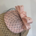 Pale pink Fascinator with navy veiling