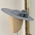 Blue boater hat with silk pom-poms