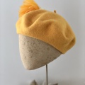 yellow beret with feather hat pin