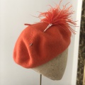orange beret with feather hat pin Holly Young