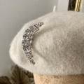 moon brooch on ivory beret