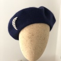 navy beret with moon brooch