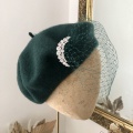dark green beret with veiling