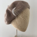 tan beret with birdcage veil