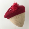Red beret with feather hat pin
