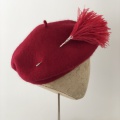 red beret with pom pom hat pin