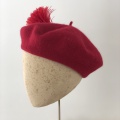 red beret with feather pompom