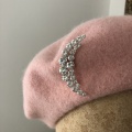 Crystal moon brooch on light pink beret