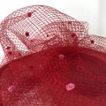 Red and pink spotty veiling on hat