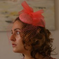 Coral fascinator with optional bird cage veil
