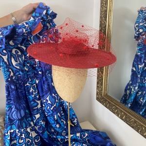 Red boater hat with spot veiling