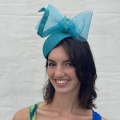 Turquoise occasion hat with butterfly