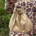 Light gold hand bag for a wedding guest