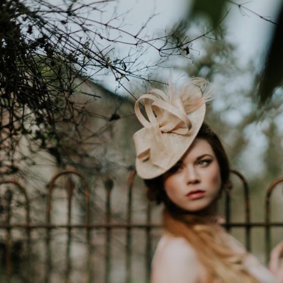 'Lydia' Nude disk shaped hat with peacock feather