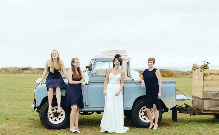 bride and bridesmaids by blue landrover