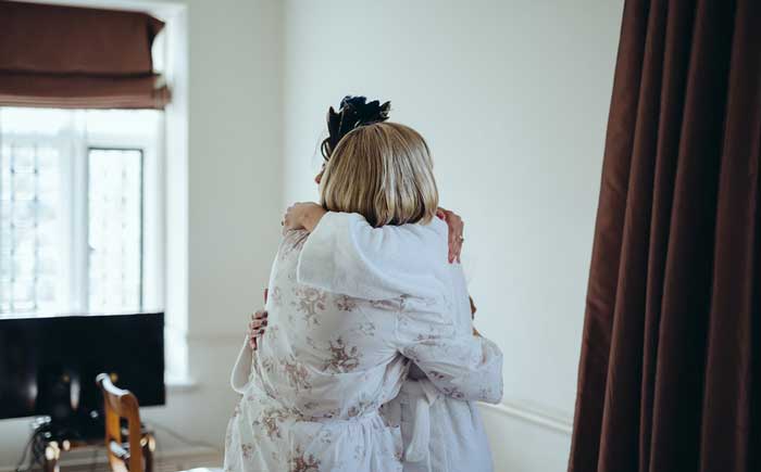 mother and daughter embrace on wedding day